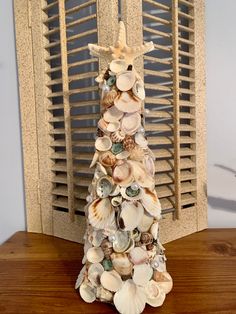 a christmas tree made out of seashells on a table