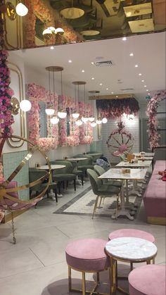 the interior of a restaurant with pink and gold decor