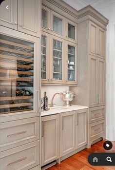 a large kitchen with wooden floors and cabinets in it's center island, along with a wine rack