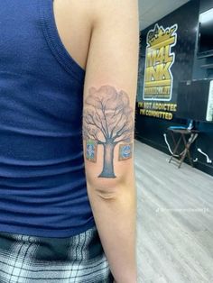 a person with a tree tattoo on their arm