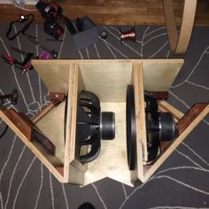 two wooden boxes with tools in them on the floor