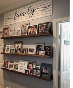 some shelves with pictures and family photos on them in a home's entryway