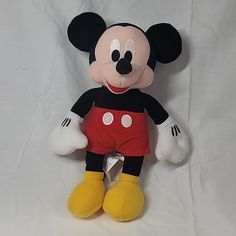 a mickey mouse stuffed animal on a white background