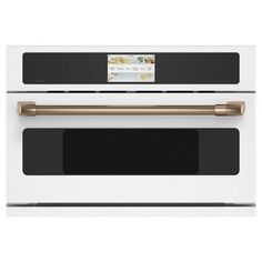 a white oven with gold trimmings and black door handles