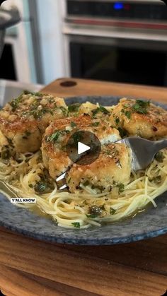 a blue plate topped with pasta covered in sauce