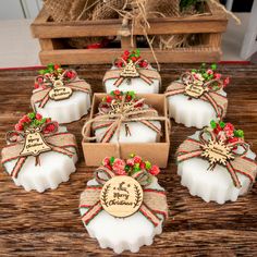 soaps decorated with bows and ribbons are sitting on a table next to some boxes