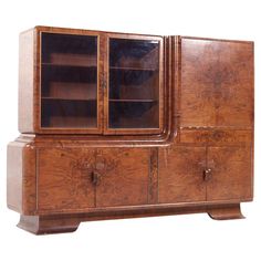 an old fashioned wooden cabinet with glass doors