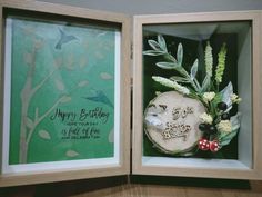 an open wooden box with a birthday card in it's center and flowers on the inside