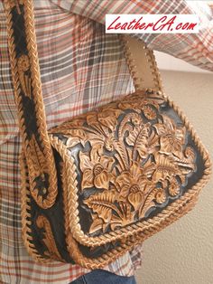 a woman holding a brown and black purse