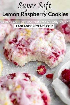 lemon raspberry cookies with white icing and cranberries on the side