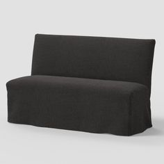 a black couch sitting on top of a white floor