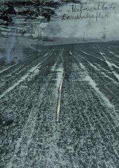 an empty field with snow on the ground and words written in black ink above it