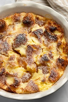 a casserole dish is covered with powdered sugar and sits on a table