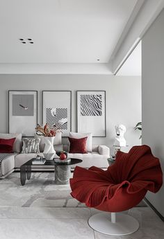 a living room filled with white furniture and red pillows