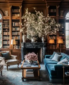 a living room filled with lots of furniture and a fire place in front of a book shelf