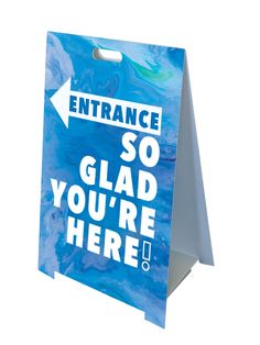 a blue and white sign with an arrow pointing to the right that says entrance so glad you're here