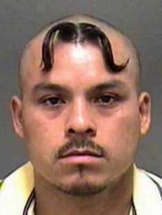 a man with a moustache on his head is shown in this mug shot