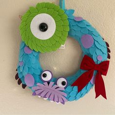 a wreath decorated with paper and googly eyes