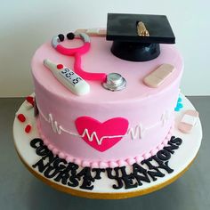 a cake decorated with pink frosting and medical items on top of it, including a stethoscope