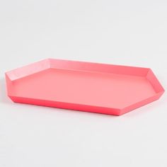 a pink tray on a white surface with no one in the photo to describe it