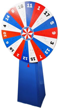 a red, white and blue spinning wheel with numbers on the side is shown in front of a white background