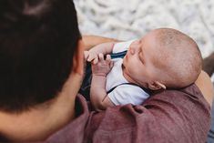 a man holding a baby in his arms