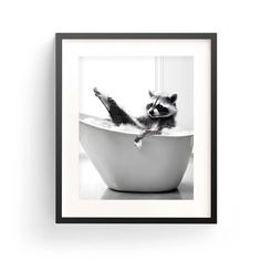 a raccoon sitting in a bathtub with its paws up