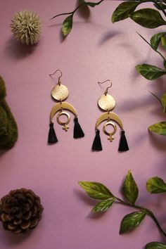 Black Tassel Gold Venus Moon Goddess Earrings ✨️ Featuring textured gold circles that dangle black tassels and venus symbol charms from u-shaped connectors. The hooks are gold plated They hang 2.75 inches  Made with nickel free materials Jewelry Grunge, Venus Symbol, Goddess Earrings, Celestial Jewelry, Moon Goddess, Grunge Style, Gold Texture, Jewelry Earrings Hoops, Grunge Fashion