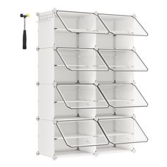 a white shelf with six bins and a black hook on it's side