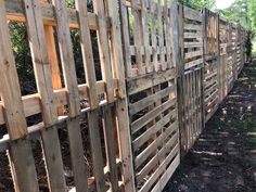 a wooden fence is shown in the woods