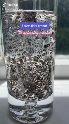 a glass filled with lots of dirt on top of a table