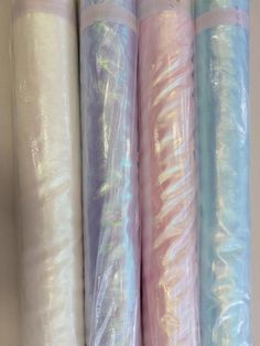 three rolls of plastic wrap sitting next to each other