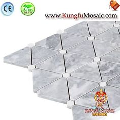 the white marble mosaic tiles are arranged in different shapes and sizes, with various colors