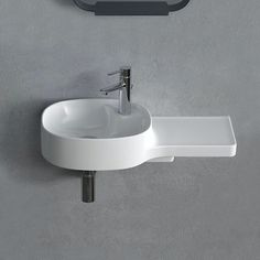 a bathroom sink sitting on top of a counter next to a wall mounted faucet