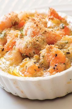 a white bowl filled with food on top of a table