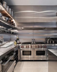 an industrial style kitchen with stainless steel appliances