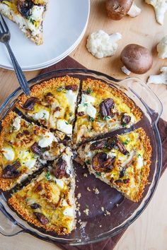 a pizza sitting on top of a pan covered in cheese and toppings next to other food