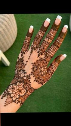 the hand is decorated with henna and flowers