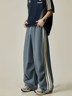 Take your workouts to the next level with our Wide-Leg Triple Stripe Athletic Pants. The wide-leg design provides maximum comfort and mobility, while the triple stripe detailing adds a touch of style. Made with high-quality materials, these pants are durable and perfect for any athletic activity. model: 174cm 61kg M material: 90% polyamide fiber (nylon). 10% polyurethane elastic fiber (spandex) Baggy Sporty Pants, Lazy Pants, Track Pants Outfit, Sporty Streetwear, Sporty Pants, High Heel Sneakers, Nylon Pants, Cool Outfit, Pantalon Large