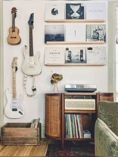 a living room with guitars on the wall and other musical instruments hanging on the wall