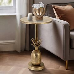 a gold pineapple side table in a living room