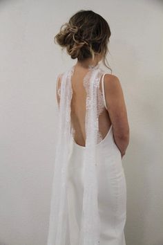 the back of a woman wearing a white wedding dress