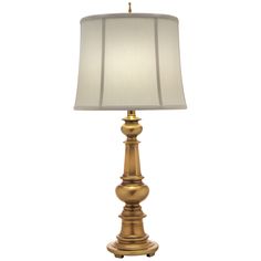 a gold lamp with a white shade on it