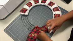 someone is making a wreath out of fabric