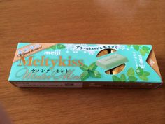 a box of mellykiss made in japan on top of a wooden table