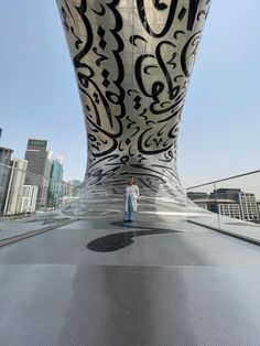 a man standing on top of a roof next to a tall building