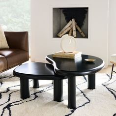 two black tables in front of a fireplace