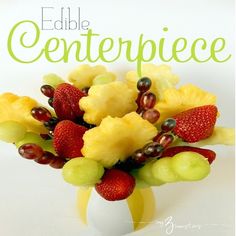 a bunch of fruit sitting on top of a yellow vase filled with watermelon, grapes and pineapples