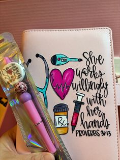 a hand holding a pink pen next to a notebook with writing on it and a stethoscope