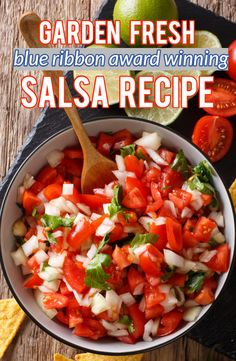 a bowl filled with salsa and tortilla chips on top of a wooden table